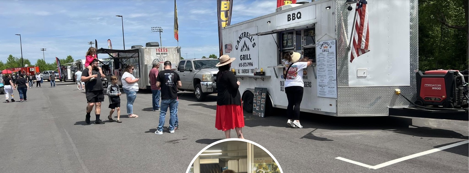 Cantrell's Grill food truck serving customers at an outdoor event, wrapped in red white and blue branding